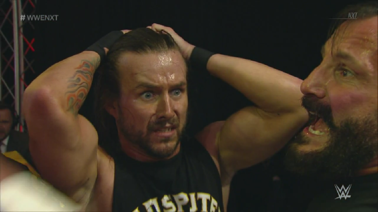NXT wrestler Adam Cole looks on in shock