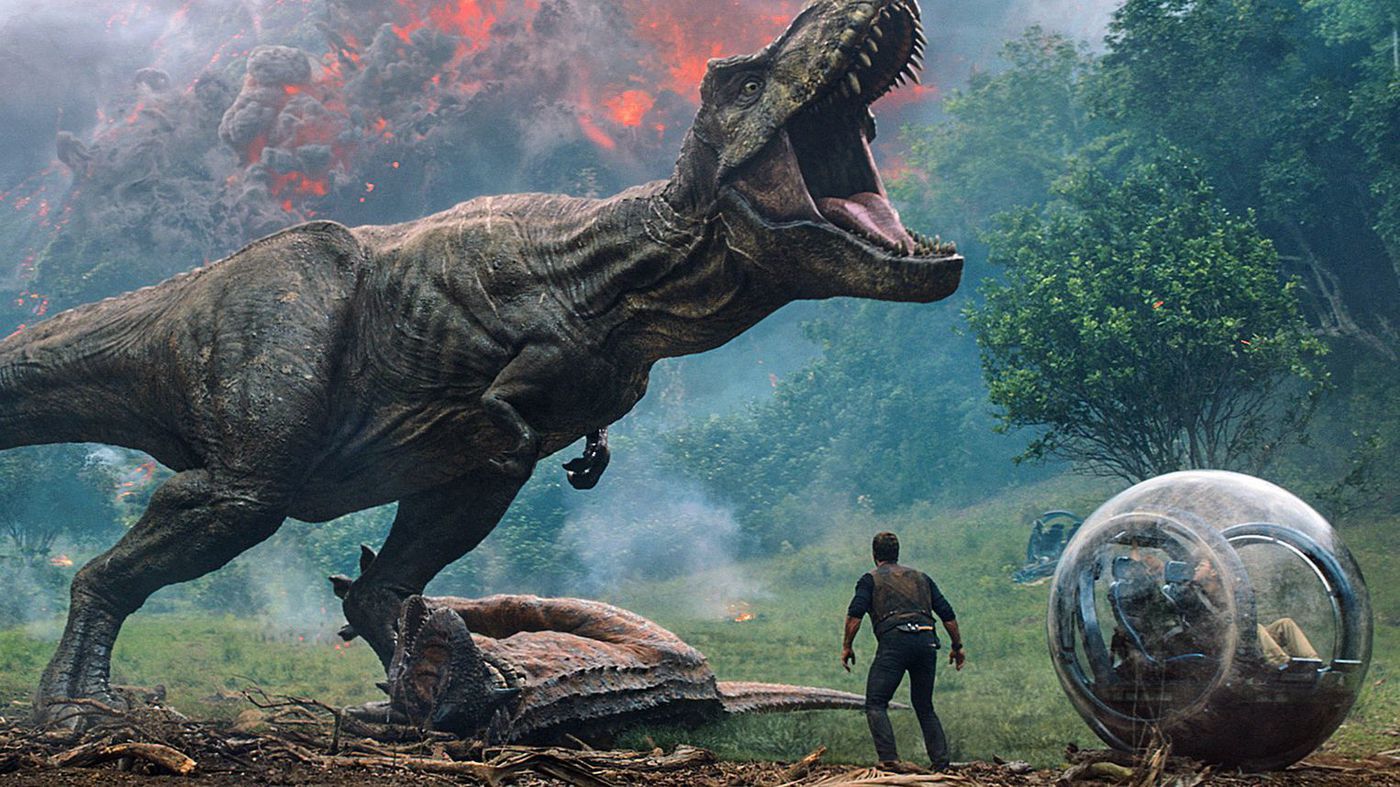 Still of Chris Pratt standing underneath a roaring T. rex in Jurassic World: Fallen Kingdom, 2018